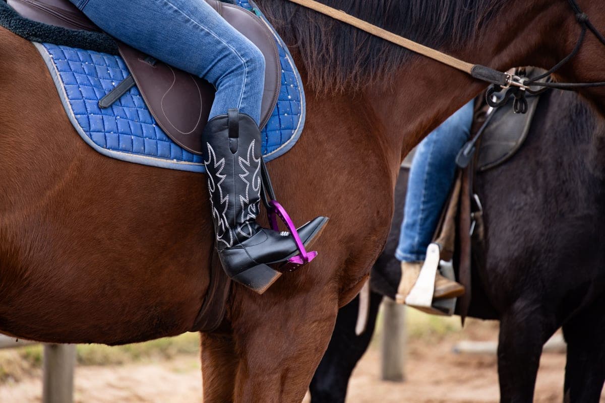 A western boot and a lace-up work boot side by side