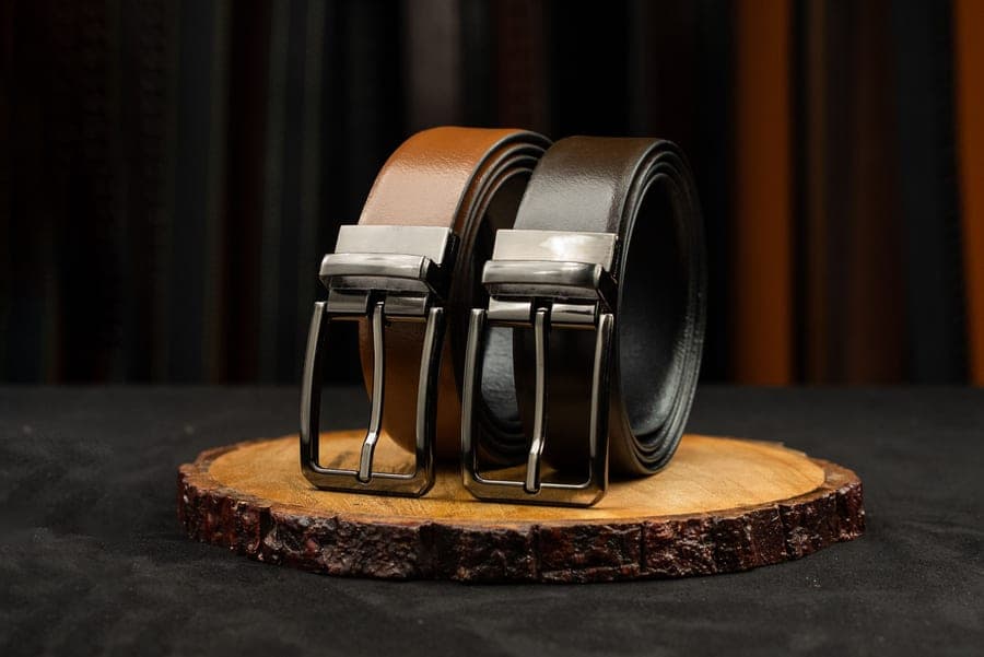 Leather belts on a wooden surface